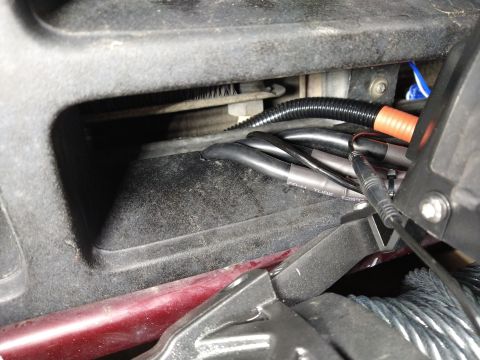 1996 Ford Bronco - This image shows a close-up view of electrical wiring and conduit within a vehicle's interior.