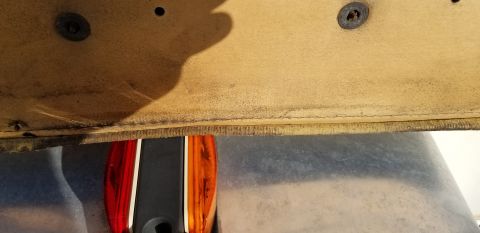 1973 Chevrolet Camaro - Close-up view of a tan interior panel and an amber taillight, likely from a vehicle.