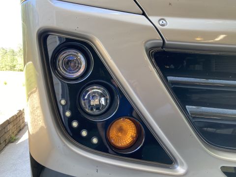 2015 Ford F-550 - Close-up of a truck's front end, showing the headlight and grille detail.