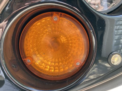 2015 Ford F-550 - Close-up of an amber turn signal light, showing the part number L03-0026 and SAE TP 00 DOT markings.