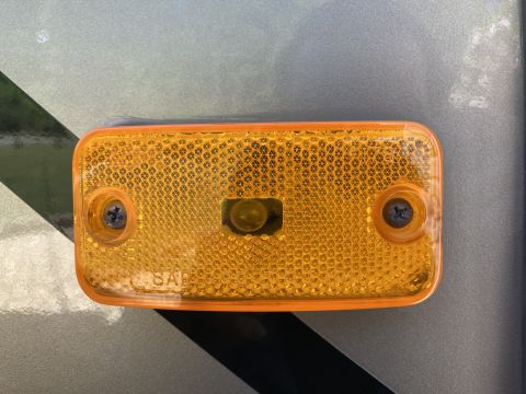 2015 Ford F-550 - This is a close-up of an amber marker light, likely for a vehicle, with visible text indicating SAE compliance.