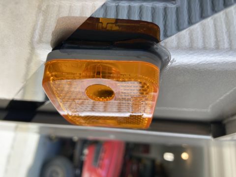 2015 Ford F-550 - Close-up of an amber marker light mounted on the underside of a vehicle.