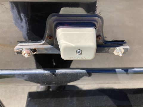 2015 Ford F-550 - The license plate light housing shows "SAE-L-91 DOT" markings, indicating its specification.