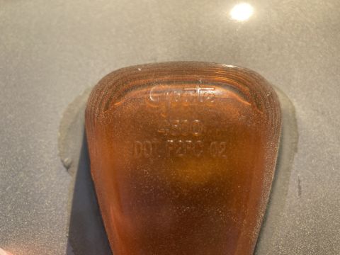 2015 Ford F-550 - Close-up of an amber marker light showing embossed text and part numbers.