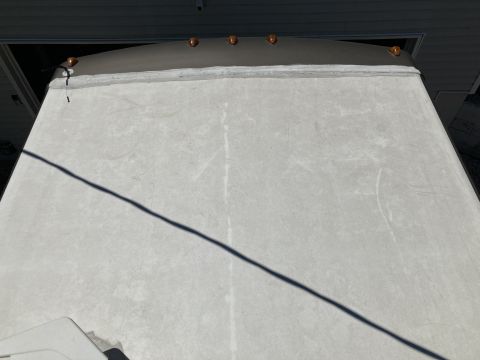 2015 Ford F-550 - The top section of a large vehicle's roof is visible, several amber marker lights along the edge.