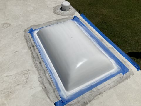 2015 Ford F-550 - Sealing a roof vent on an RV. The area is taped off for a clean sealant application.