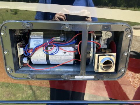2015 Ford F-550 - Close-up of internal components of an RV water heater, showing wiring and plumbing connections.