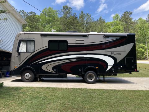 2015 Ford F-550 - Side view of a Fleetwood Flair motorhome with a distinctive graphic design.