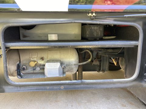 2015 Ford F-550 - A close-up view of an open compartment containing various pipes and equipment.