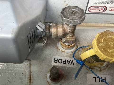 2015 Ford F-550 - Close-up of a propane tank valve, cap, and 'VAPOR' label.