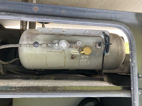 2015 Ford F-550 - horizontal cylindrical LPG fuel tank with vapor and fill fittings mounted under a vehicle body cross member.