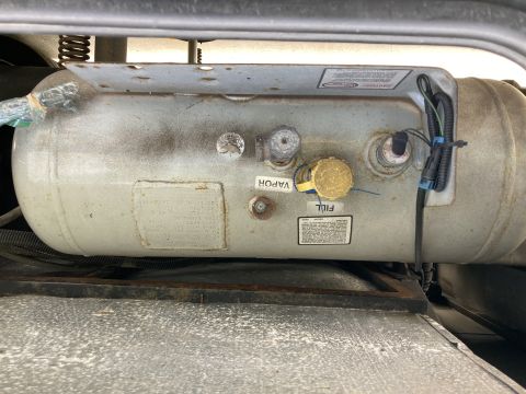 2015 Ford F-550 - Close-up of a propane tank showing its fill and vapor ports and attached wiring.