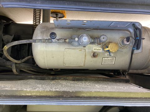 2015 Ford F-550 - Close-up of a vehicle's propane tank, showing various valves and connections for fuel.