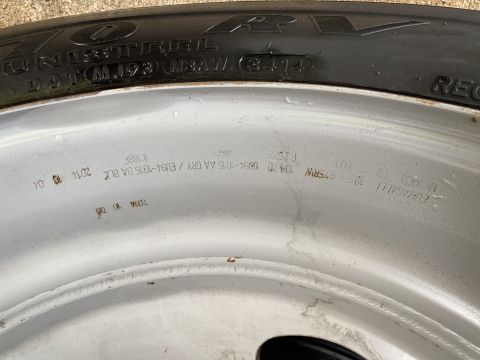 2015 Ford F-550 - A close-up view of a vehicle's wheel and tire, showing manufacturing details and dates.