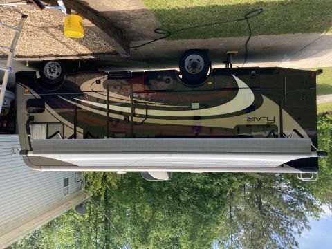 2015 Ford F-550 - This motorhome features a "Flair" graphic on its side, indicating it is a recreational vehicle.