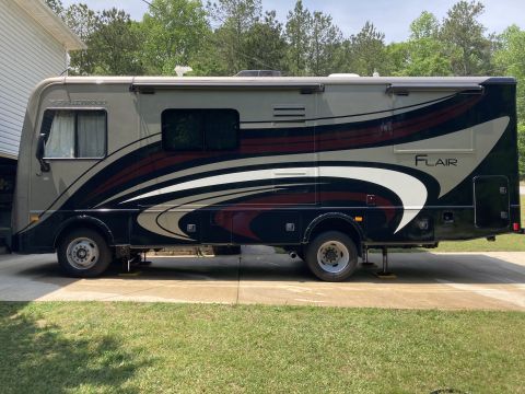 2015 Ford F-550 - This motorhome features a "Flair" decal on its side, with a distinctive graphic design in dark grey, light grey, and maroon.