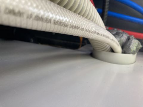 2015 Ford F-550 - Close-up of potable water hose and insulation, with text indicating pressure rating.
