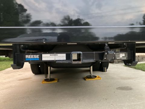 2015 Ford F-550 - Rear view of a trailer hitch assembly, Reese branding and a warning label.