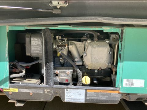 2015 Ford F-550 - Close-up view of a Cummins Onan generator, showing its engine components and air filter assembly.