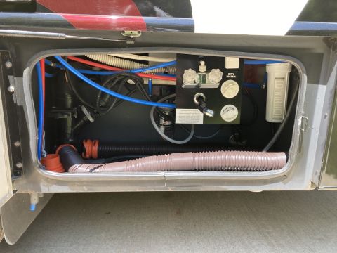 2015 Ford F-550 - This compartment contains the city water hookup, a water filter, and various plumbing lines and hoses.