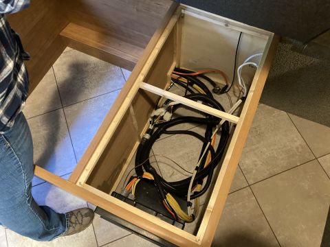 2015 Ford F-550 - A look inside an RV's storage compartment reveals a complex network of electrical wiring and connectors.