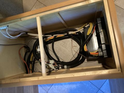 2015 Ford F-550 - A complex electrical wiring harness and control module are visible within a wooden compartment.