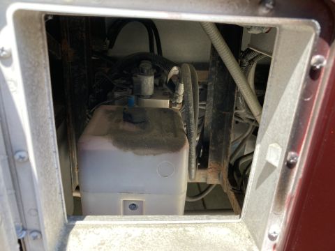 2015 Ford F-550 - Close-up of a hydraulic system component, likely part of a lift or auxiliary system, within a vehicle's chassis.