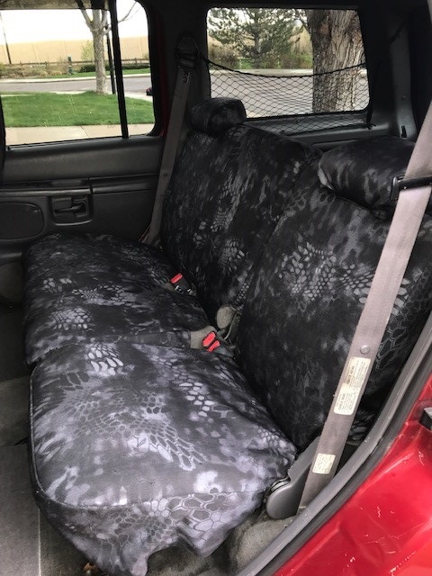 2000 Ford Explorer - Interior view of a 2000 Ford Explorer, aftermarket camouflage seat covers on the rear bench seat.