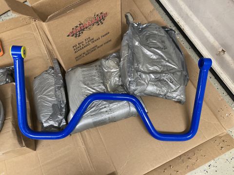 2015 Ford F-550 - A blue sway bar and bags of balancing beads are shown, packaged for shipping.