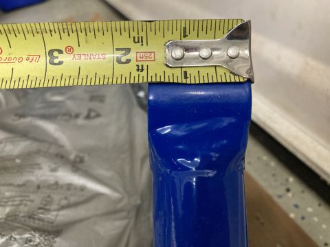 2015 Ford F-550 - A blue metal bar is measured with a Stanley tape measure, indicating a length of about 2.5 inches.