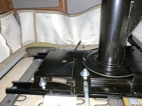 2015 Ford F-550 - The underside of a vehicle seat shows its mounting hardware and swivel base.