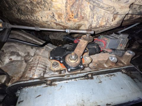 1973 Ford Bronco - Hurst shift cable mounted to the transmission lever with the end of the stock Bronco carburetor linkage welded to a nut that fit the cable.…