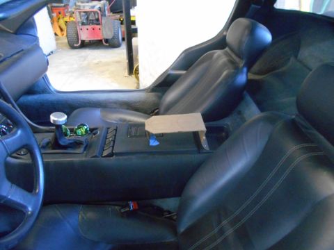 1992 Ford Bronco - The interior of a car is shown, with a view of a red tractor outside through the open door.