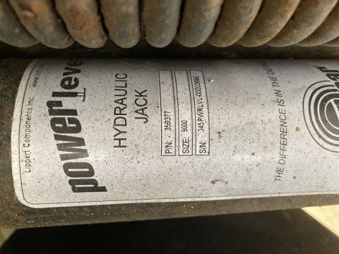 2015 Ford F-550 - A label on a hydraulic jack reads "powerleve HYDRAULIC JACK" with a part number, size, and serial number visible. The label also includes "…
