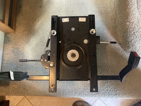 2015 Ford F-550 - black fifth-wheel trailer hitch head with pivot plate and locking handle resting on carpeted floor.