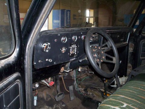 1978 Ford Bronco - The interior of a 1978 Ford Bronco shows a modified dashboard with aftermarket gauges and steering wheel.