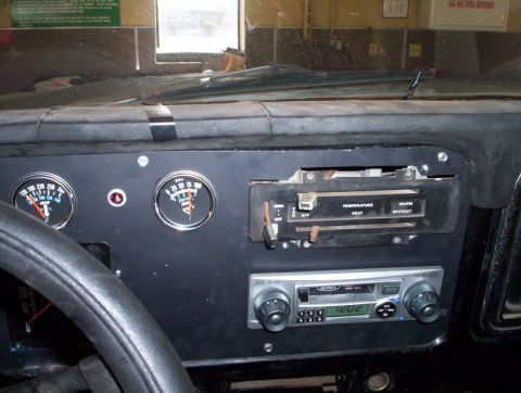 1978 Ford Bronco - The interior dashboard features aftermarket gauges and a retro radio, suggesting customization.