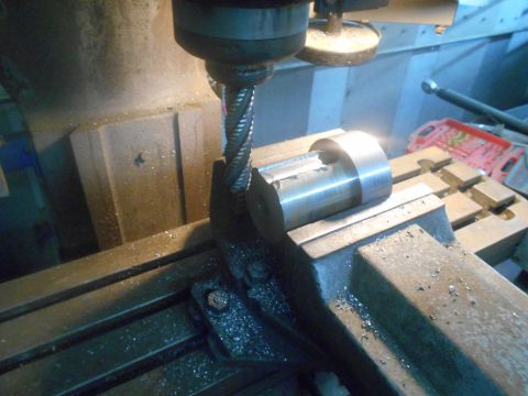 1992 Ford Bronco - A metal workpiece is being machined on a milling machine. Metal shavings are visible on the machine bed.