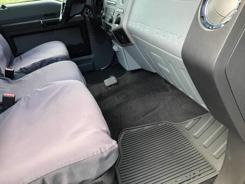 Interior of a Ford Super Duty pickup truck showing passenger seat and dashboard.