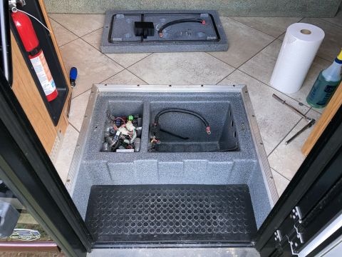 2015 Ford F-550 - An open compartment reveals electrical wiring and components, with a fire extinguisher mounted on the left and a roll of paper towels and c…