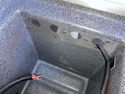 2015 Ford F-550 - Close-up of an interior compartment with visible wiring and a storage bin.