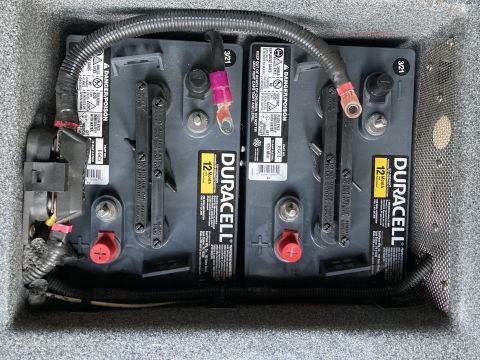 2015 Ford F-550 - Two Duracell batteries are visible in a compartment, connected by wiring and surrounded by wiring.