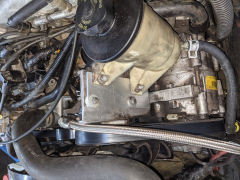 1973 Ford Bronco - We used a piece of a broken aluminum yard stick to move the P/S reservoir down and back. It wasn't quite enough so we had to take a notch o…