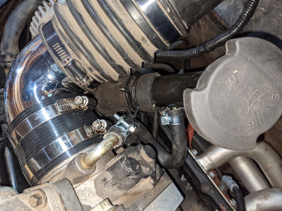 The oil filler ran into the intake tube and I just happened to have a Buick 3.8 sitting on the shop floor and its lower radiator hose was the perfect size to fit the filler tube!  It had a ~45 degree bend in it and it worked perfectly.  We rarely get this lucky cobbling stuff together!  The hose specs say it's 1 9/32" diameter and it should be a Gates 22373.