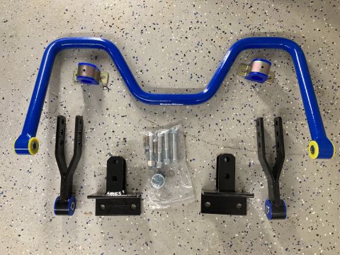 2015 Ford F-550 - This image shows a blue sway bar kit, including the bar, mounting brackets, and hardware, laid out on a speckled floor.