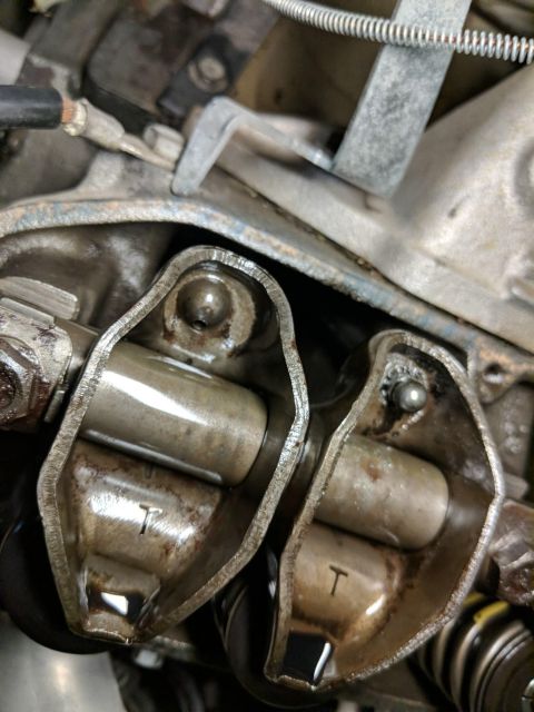 1974 Dodge Challenger - Detailed view of engine valve train components, showing rocker arms and valve stems with visible markings.