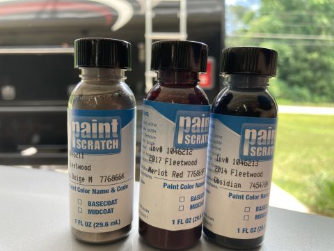2015 Ford F-550 - Three bottles of touch-up paint from PaintScratch.com are displayed in front of a blurred vehicle. The bottles are labeled with different p…