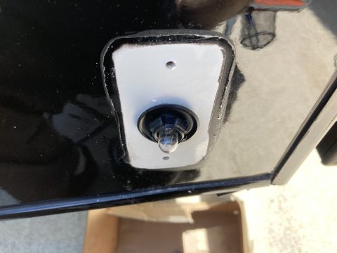 2015 Ford F-550 - A close-up view shows a small, clear bulb with a black housing mounted on a white gasket. The bulb is set into a black, glossy surface, lik…