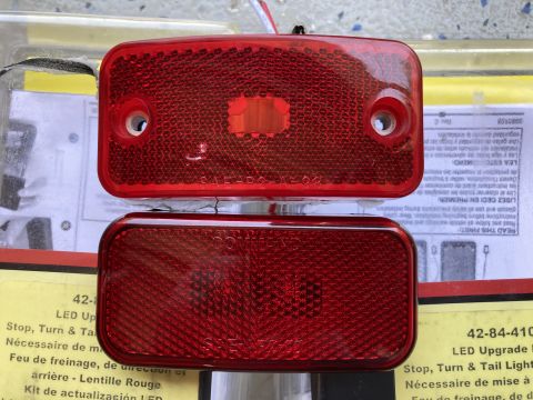 2015 Ford F-550 - Two red rectangular LED trailer lights are shown stacked vertically. The top light has "SAE P2 A 98" embossed on it, and the bottom light h…