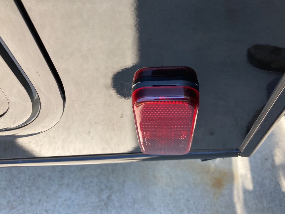 Red tail light on a dark surface